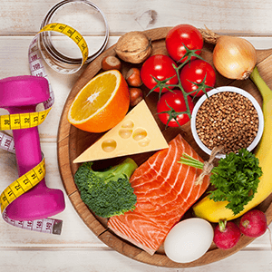 Top view of a tray of foods, with a weight and tape measure next to them on the table